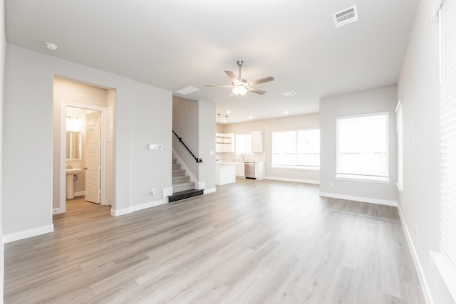 3011 Valley Peak Dr, Houston, TX 77063 - unfurnished living room with visible vents, stairs, ceiling fan, and baseboards