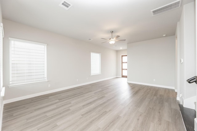 3011 Valley Peak Dr, Houston, TX 77063 - unfurnished living room featuring visible vents, a ceiling fan, light wood-style flooring, and baseboards
