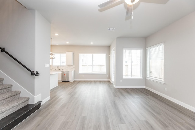 3011 Valley Peak Dr, Houston, TX 77063 - unfurnished living room with baseboards, ceiling fan, light wood-type flooring, and visible vents