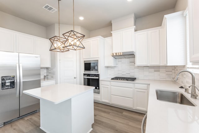 3011 Valley Peak Dr, Houston, TX 77063 - kitchen with a kitchen island, backsplash, visible vents, a sink, and stainless steel appliances
