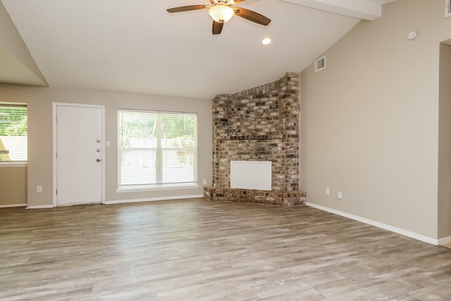 unfurnished living room featuring a ceiling fan, baseboards, vaulted ceiling with beams, and wood finished floors