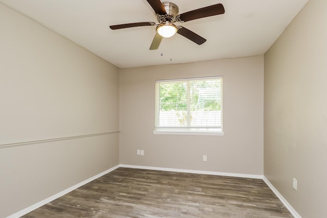 unfurnished room with baseboards, a ceiling fan, and wood finished floors