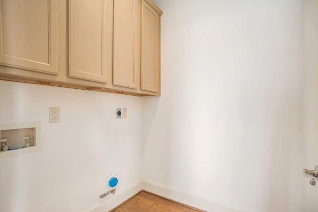 washroom featuring washer hookup, electric dryer hookup, light wood-type flooring, cabinet space, and baseboards