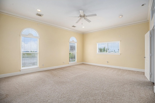unfurnished room with crown molding, ceiling fan, light carpet, and visible vents
