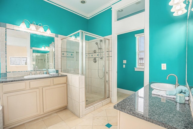 full bath with vanity, tile patterned floors, ornamental molding, and a stall shower