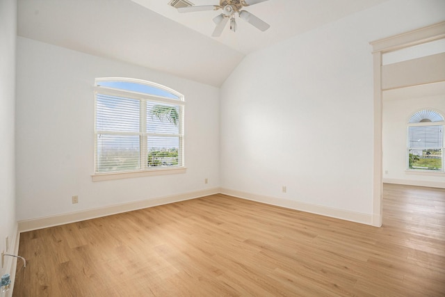 spare room featuring baseboards, a ceiling fan, light wood-style flooring, and lofted ceiling