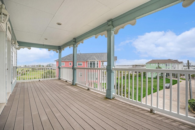 wooden deck with a lawn and a residential view
