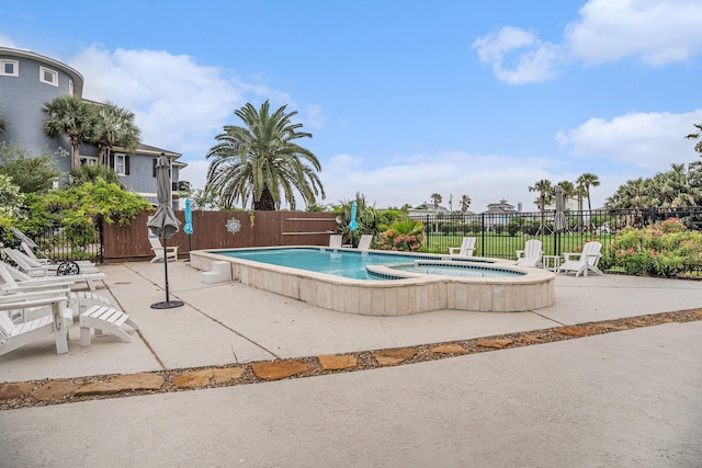 view of pool featuring fence, a fenced in pool, a patio, and an in ground hot tub