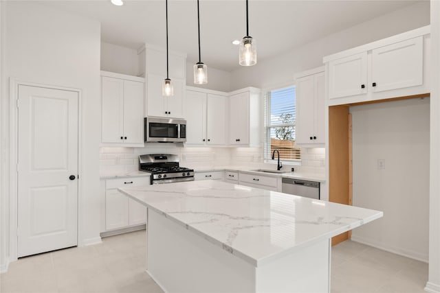 kitchen featuring stainless steel appliances, white cabinetry, a sink, and tasteful backsplash