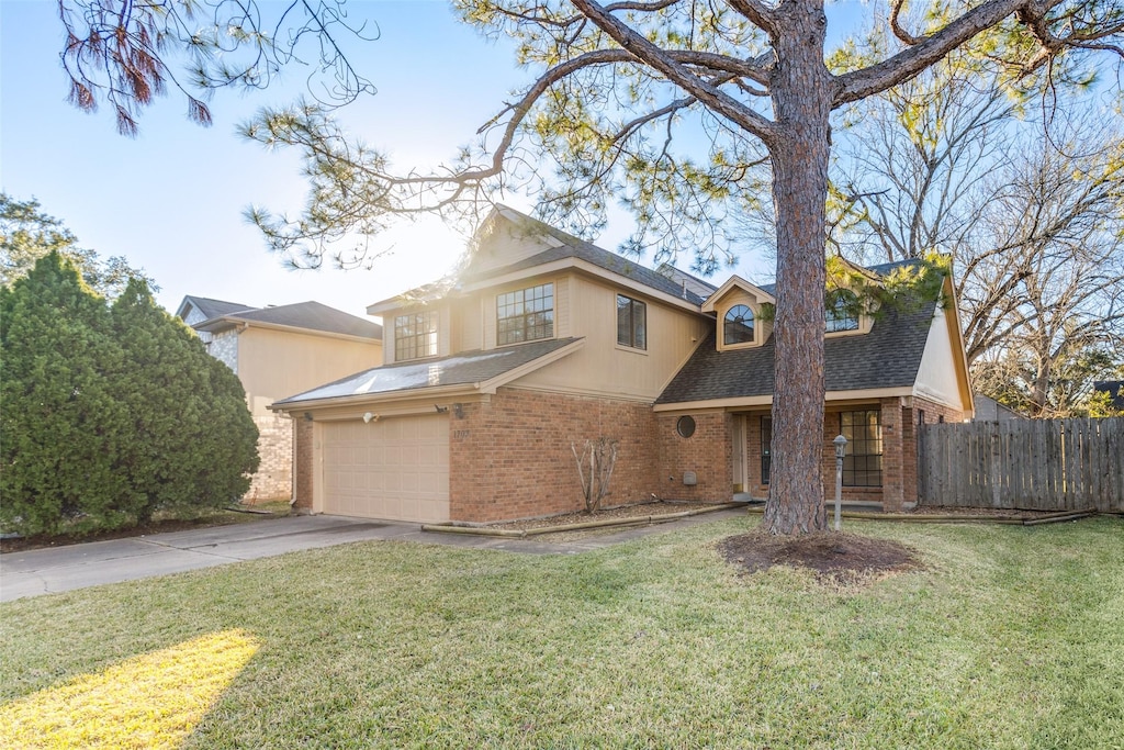 1703 Regal Blue Ct, Fresno, TX 77545 - traditional home with fence, a shingled roof, brick siding, a front yard, and driveway