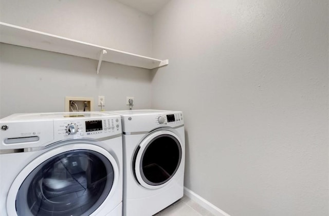 laundry room with washer and dryer, light tile patterned flooring, laundry area, and baseboards