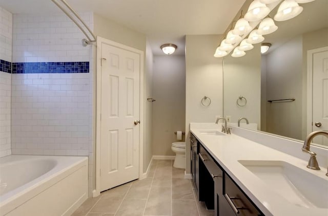 full bathroom featuring double vanity, toilet, a sink, and tile patterned flooring