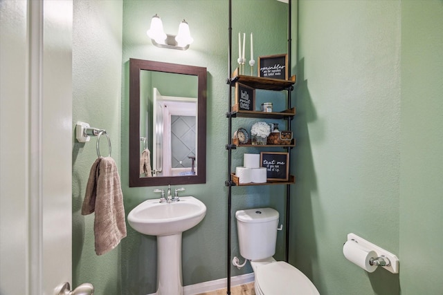 half bath featuring a sink and toilet