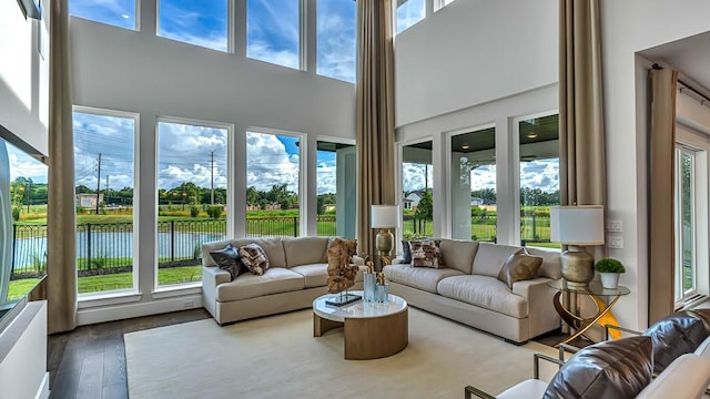 sunroom / solarium featuring a water view and a wealth of natural light