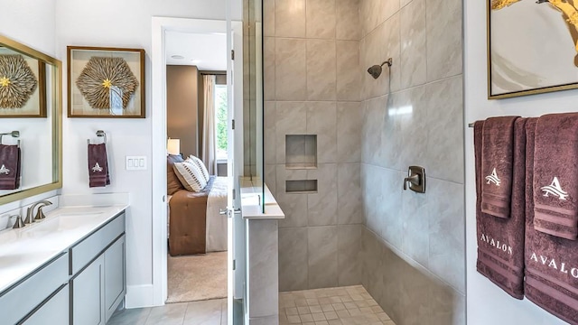 ensuite bathroom with vanity, tile patterned floors, walk in shower, and ensuite bath