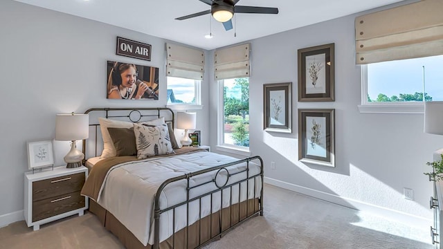 bedroom with baseboards, ceiling fan, and light colored carpet