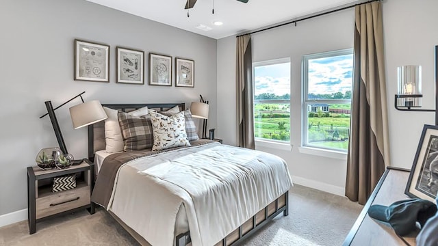 bedroom featuring baseboards, carpet flooring, a ceiling fan, and visible vents
