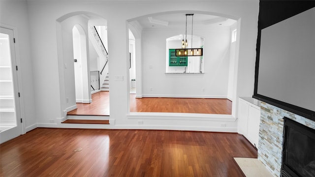4524 Rose St, Houston, TX 77007 - unfurnished living room featuring baseboards, ornamental molding, stairs, and wood finished floors