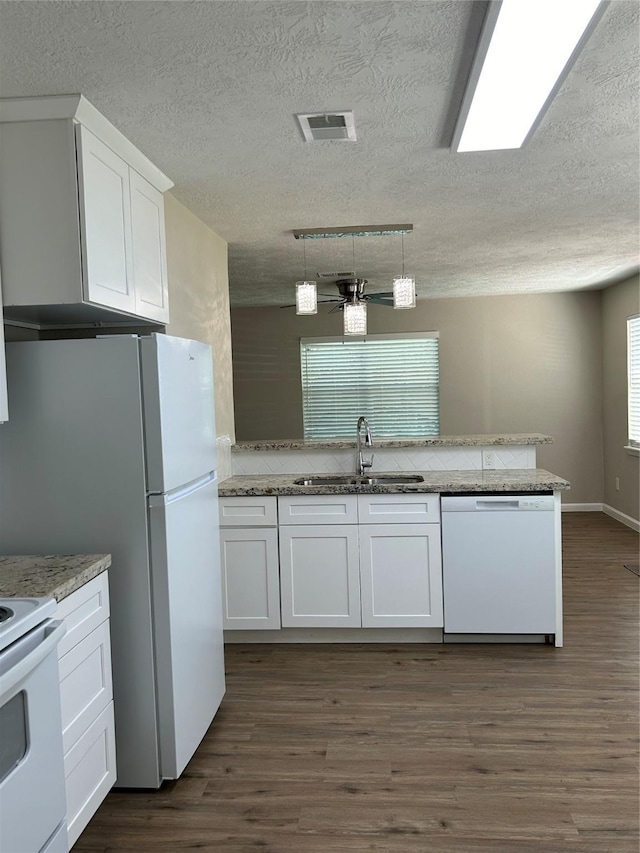105 Will St, Willis, TX 77378 - kitchen featuring visible vents, white appliances, ceiling fan, white cabinets, and a sink