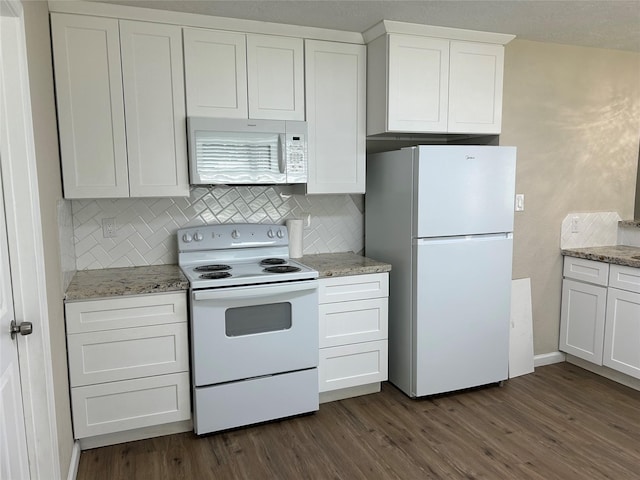 105 Will St, Willis, TX 77378 - kitchen featuring tasteful backsplash, white appliances, dark wood-style floors, and white cabinetry
