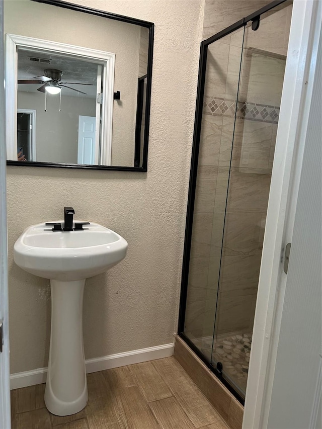 105 Will St, Willis, TX 77378 - full bathroom with baseboards, a ceiling fan, a stall shower, and visible vents