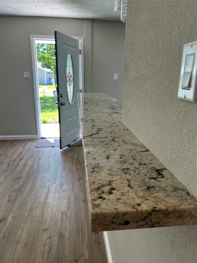 105 Will St, Willis, TX 77378 - entryway with baseboards, a textured wall, and wood finished floors