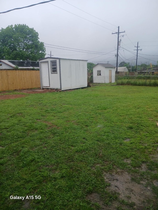 105 Will St, Willis, TX 77378 - view of yard featuring an outbuilding, fence, and a storage shed