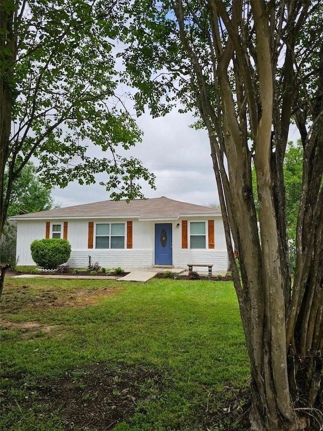 105 Will St, Willis, TX 77378 - ranch-style house with brick siding and a front yard