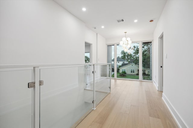 1550 Gardenia Dr, Houston, TX 77018 - hallway with light wood-style floors, recessed lighting, and a chandelier