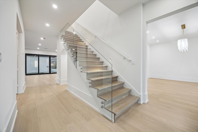 1550 Gardenia Dr, Houston, TX 77018 - stairway with wood finished floors, baseboards, recessed lighting, and a chandelier