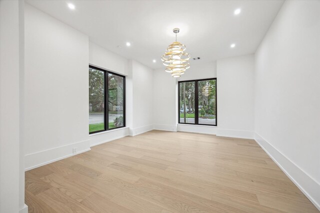 1550 Gardenia Dr, Houston, TX 77018 - unfurnished room with light wood-style flooring, a chandelier, and recessed lighting