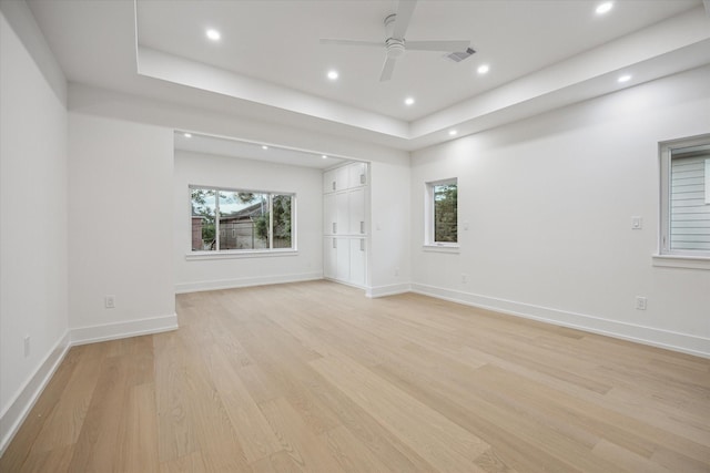 1550 Gardenia Dr, Houston, TX 77018 - empty room with light wood-type flooring, recessed lighting, a ceiling fan, a tray ceiling, and baseboards