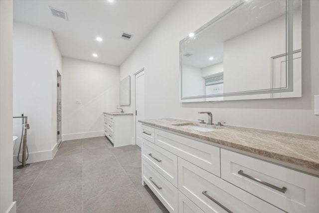 1550 Gardenia Dr, Houston, TX 77018 - full bathroom featuring two vanities, a shower stall, a freestanding tub, recessed lighting, and baseboards