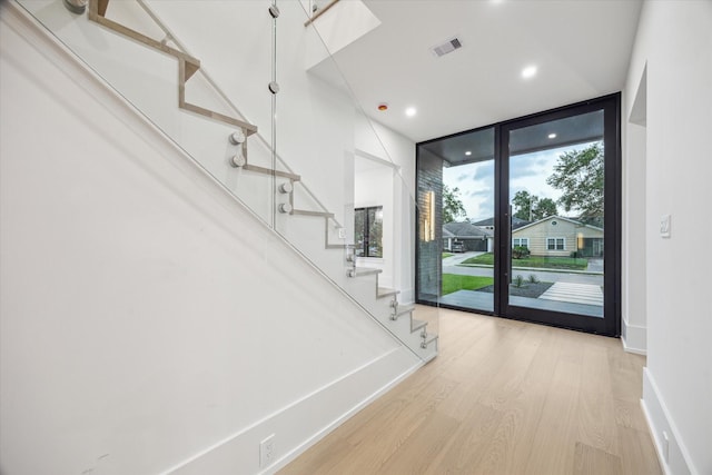 1550 Gardenia Dr, Houston, TX 77018 - foyer featuring stairs, wood finished floors, expansive windows, baseboards, and recessed lighting