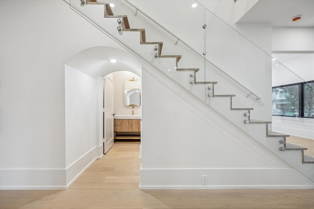 1550 Gardenia Dr, Houston, TX 77018 - stairs featuring wood finished floors, baseboards, and arched walkways