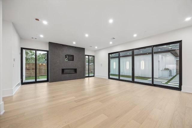 1550 Gardenia Dr, Houston, TX 77018 - unfurnished living room with light wood-style flooring, healthy amount of natural light, baseboards, and recessed lighting