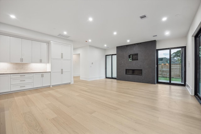 1550 Gardenia Dr, Houston, TX 77018 - unfurnished living room with light wood finished floors, recessed lighting, baseboards, and a large fireplace