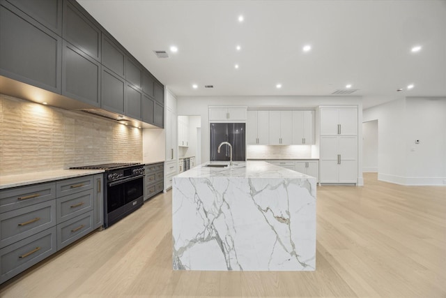 1550 Gardenia Dr, Houston, TX 77018 - kitchen featuring high end appliances, decorative backsplash, light wood finished floors, light stone countertops, and recessed lighting