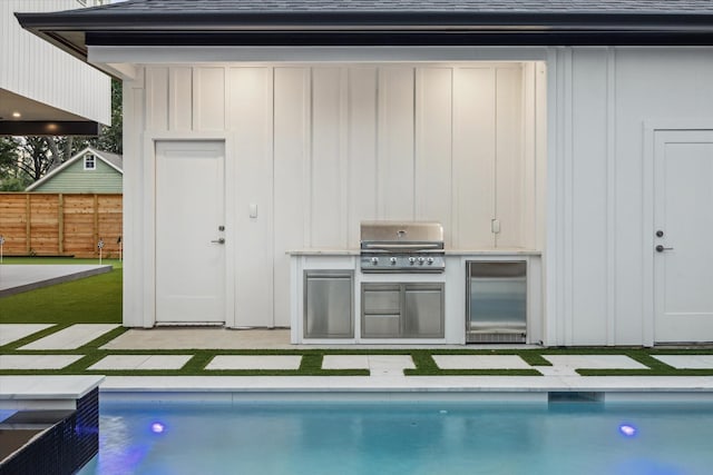 1550 Gardenia Dr, Houston, TX 77018 - rear view of property featuring board and batten siding, a shingled roof, an outdoor kitchen, and a patio
