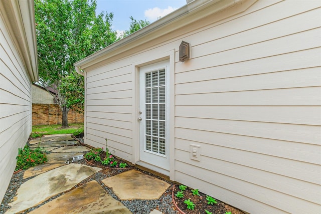 doorway to property with fence and a patio