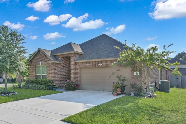 single story home with a garage, a front yard, roof with shingles, and brick siding