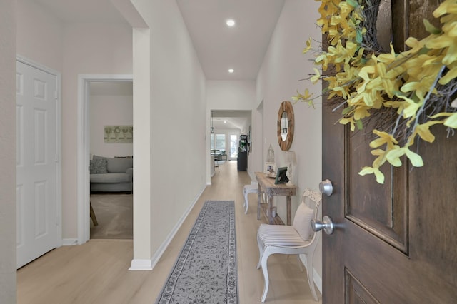 foyer with light wood-type flooring, recessed lighting, and baseboards