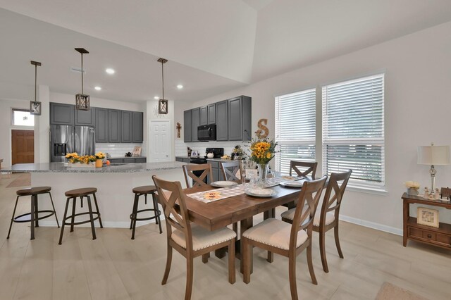 dining space with recessed lighting, baseboards, vaulted ceiling, and visible vents