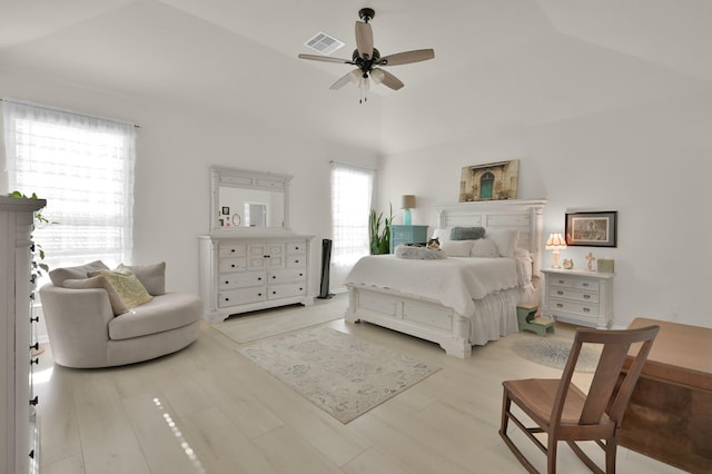 bedroom with visible vents, a ceiling fan, lofted ceiling, and wood finished floors