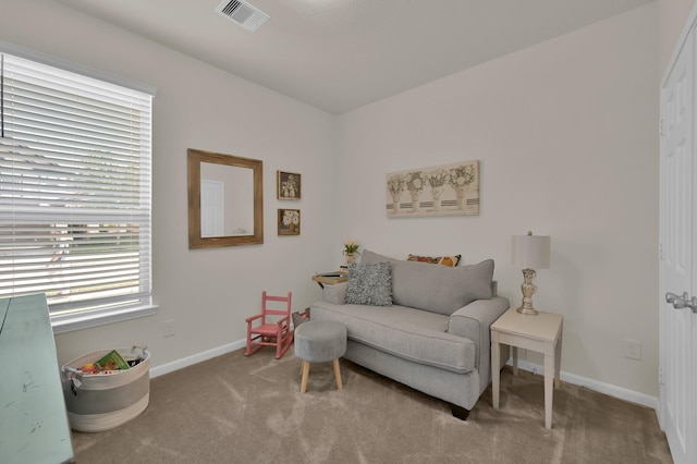 sitting room featuring carpet floors, baseboards, and visible vents