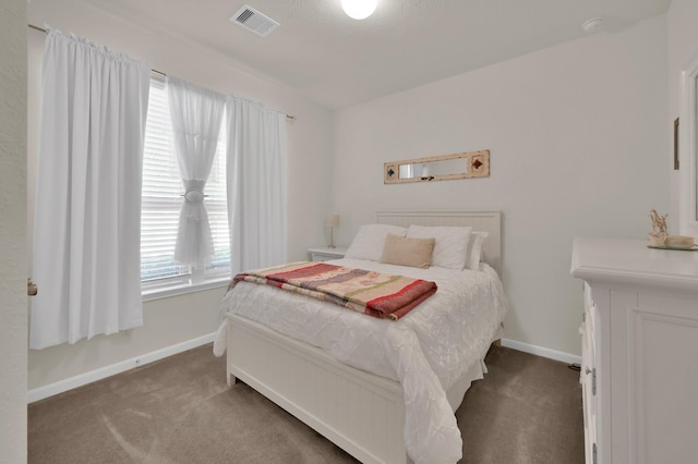 carpeted bedroom with baseboards and visible vents