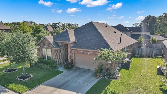 view of front of property with an attached garage, a front lawn, roof with shingles, and driveway