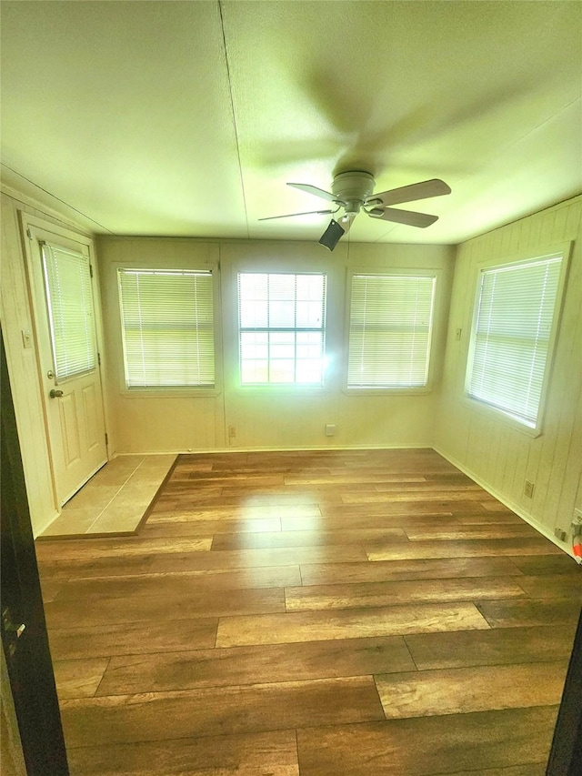 empty room with ceiling fan and hardwood / wood-style floors