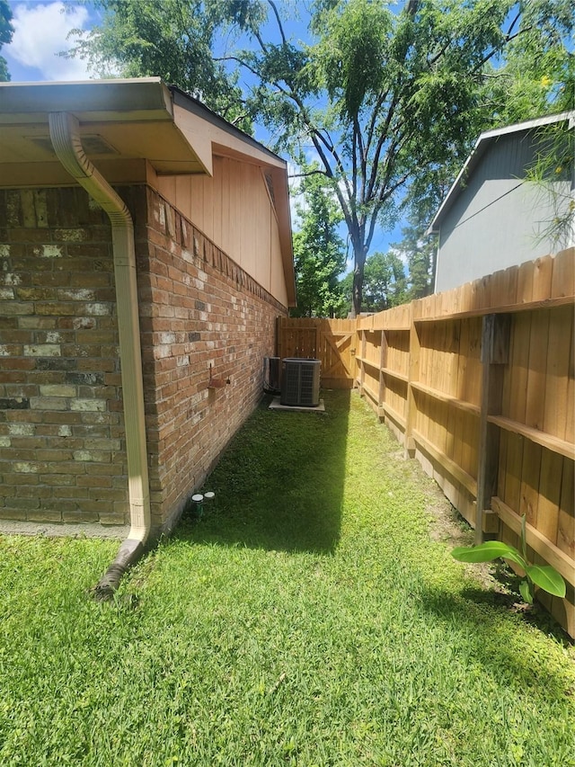 view of yard with fence and cooling unit
