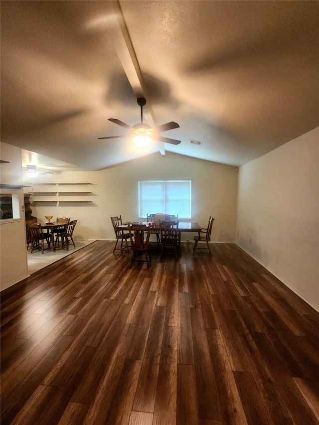dining area with a ceiling fan, vaulted ceiling, hardwood / wood-style flooring, and visible vents
